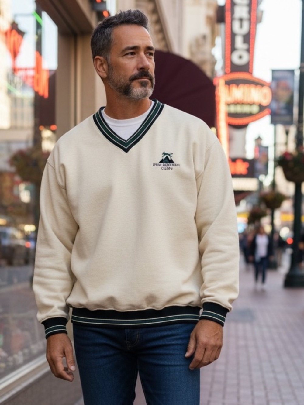 CHANEL Cream V-Neck Sweater with Dark Green & Black Trim and Embroidered Logo